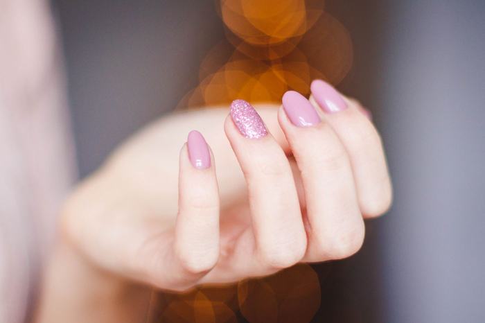 Soft pink manicure with one glitter accent nail